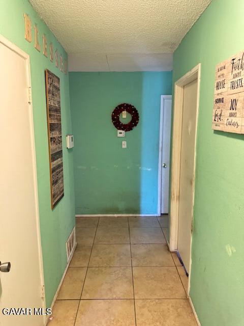 45529 Sancroft Ave, Lancaster, CA 93535 - hall featuring a textured ceiling and tile patterned flooring