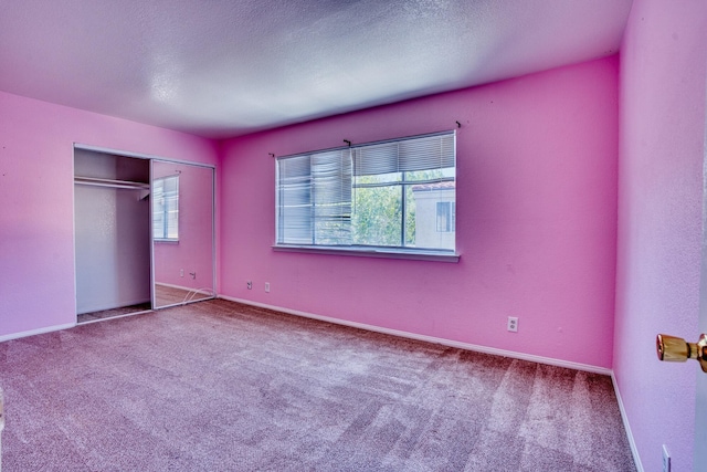 43441 W 30th St Unit 4, Lancaster, CA 93536 - unfurnished bedroom with carpet floors, a closet, baseboards, and a textured ceiling