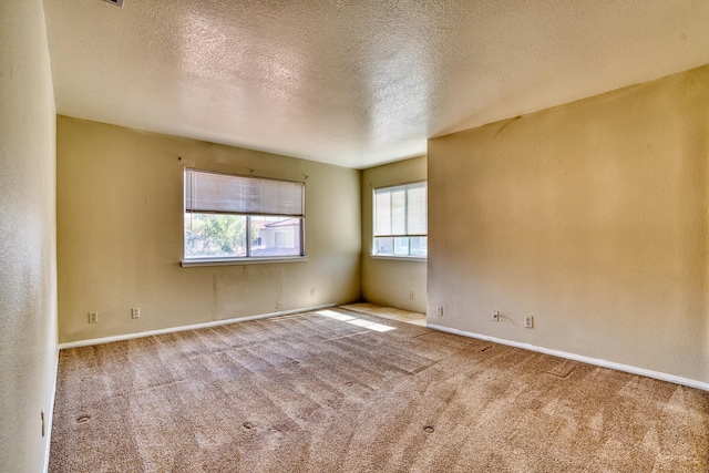 43441 W 30th St Unit 4, Lancaster, CA 93536 - empty room featuring carpet floors, a textured ceiling, and baseboards
