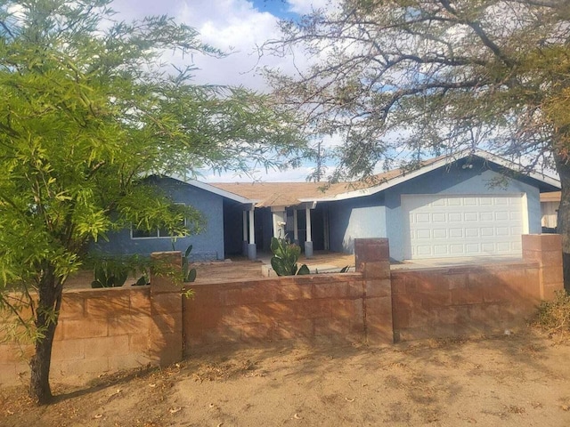 single story home featuring a garage