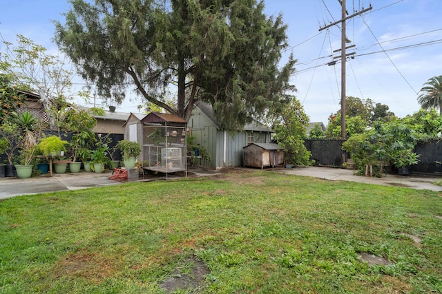 1320 W 50th St, Los Angeles, CA 90037 - view of yard featuring an outbuilding, a fenced backyard, and a storage unit