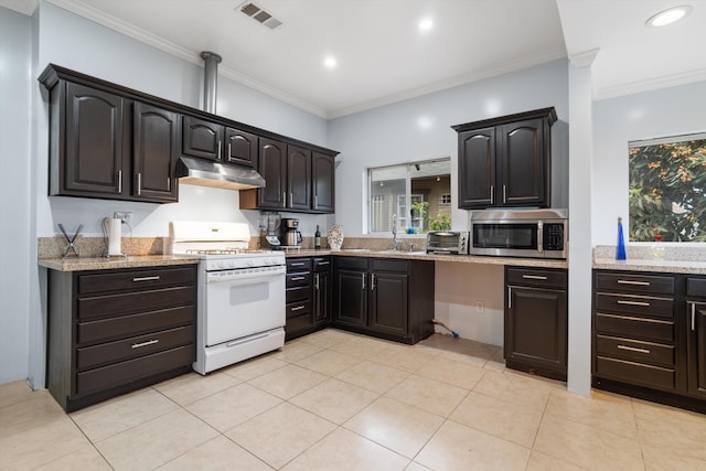 1320 W 50th St, Los Angeles, CA 90037 - kitchen featuring under cabinet range hood, white gas range oven, stainless steel microwave, and light stone countertops