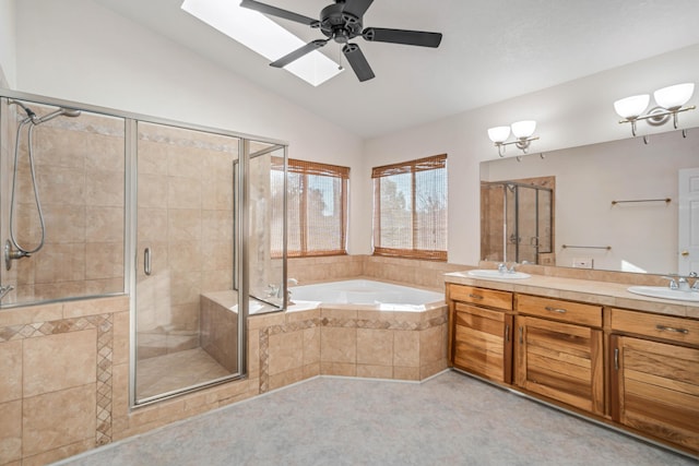 bathroom with vanity, separate shower and tub, vaulted ceiling with skylight, and ceiling fan