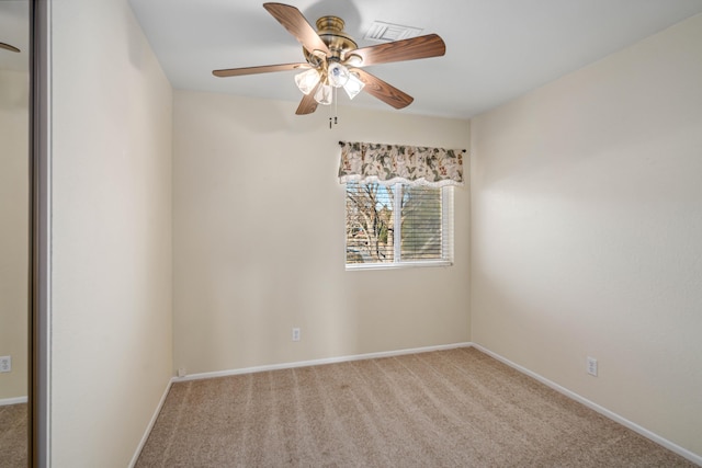 carpeted empty room featuring ceiling fan