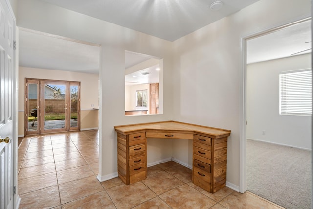 office with light carpet, built in desk, and plenty of natural light