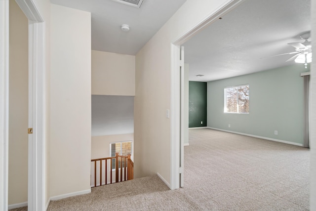 hallway with light colored carpet