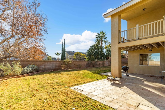 view of yard featuring a patio and a balcony