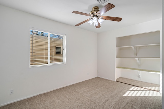 spare room featuring light colored carpet and ceiling fan