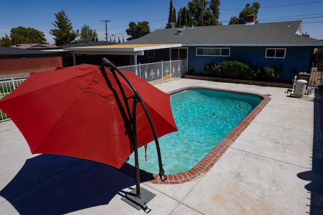 view of swimming pool with a patio, a fenced in pool, and fence
