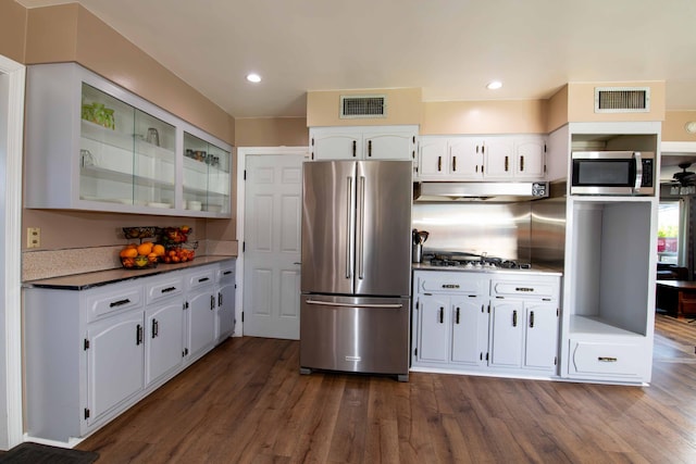 kitchen featuring under cabinet range hood, appliances with stainless steel finishes, visible vents, and white cabinets