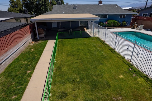 view of pool featuring a lawn, a patio area, a fenced in pool, and a fenced backyard