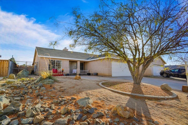 ranch-style house with covered porch and a garage