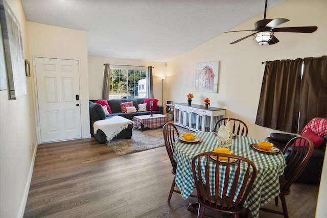 living room with hardwood / wood-style floors, a textured ceiling, ceiling fan, and lofted ceiling