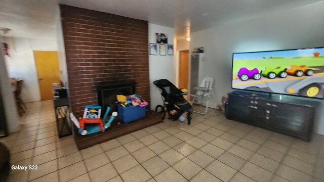 tiled living room with a brick fireplace