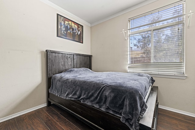 bedroom featuring crown molding and dark wood-type flooring