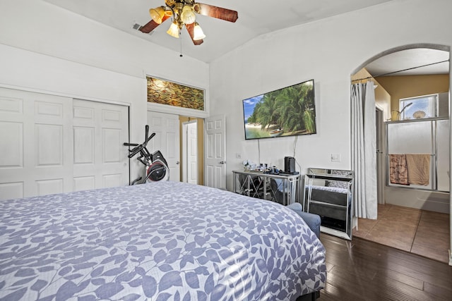 bedroom featuring ceiling fan, dark wood-type flooring, and vaulted ceiling