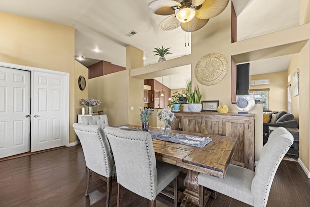 dining space with high vaulted ceiling, ceiling fan, and dark hardwood / wood-style flooring