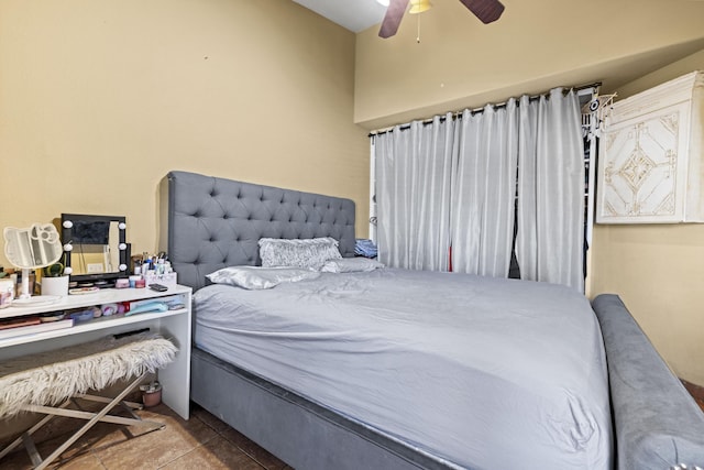 bedroom with ceiling fan and light tile patterned floors