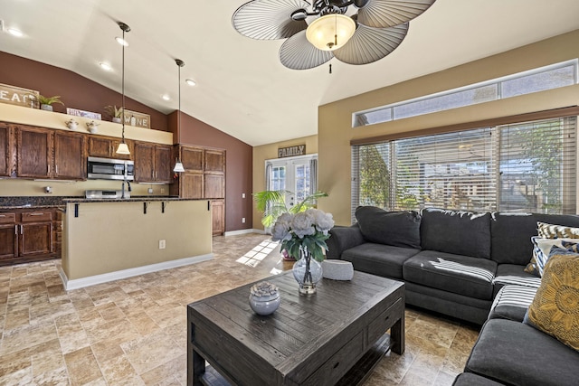 living room featuring ceiling fan, lofted ceiling, and french doors