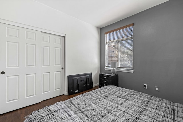 bedroom featuring dark hardwood / wood-style floors and a closet