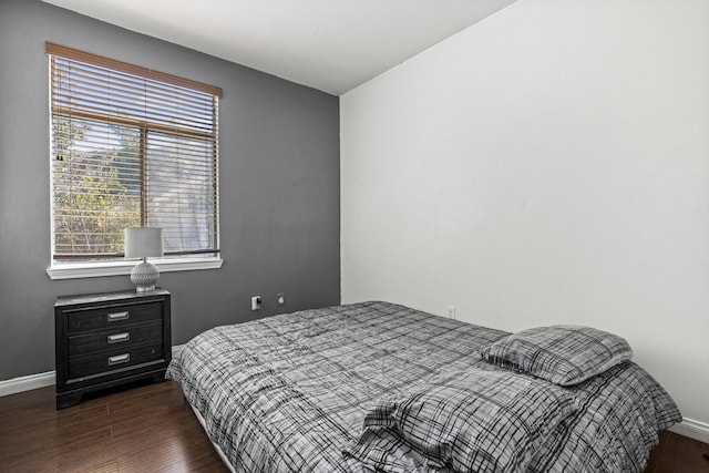 bedroom featuring dark hardwood / wood-style floors and multiple windows