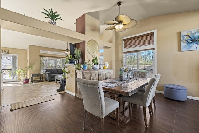 dining space with ceiling fan, a healthy amount of sunlight, dark hardwood / wood-style flooring, and lofted ceiling