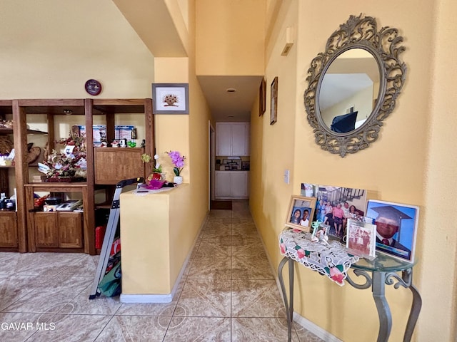 1816 Orange St, Rosamond, CA 93560 - hallway with tile patterned flooring and a towering ceiling