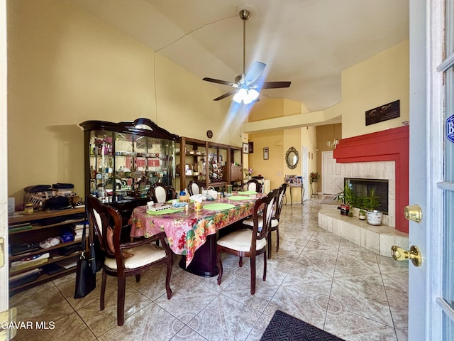 1816 Orange St, Rosamond, CA 93560 - tiled dining space with vaulted ceiling, a ceiling fan, and a tiled fireplace