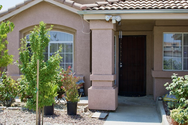 1816 Orange St, Rosamond, CA 93560 - view of exterior entry with a tile roof and stucco siding