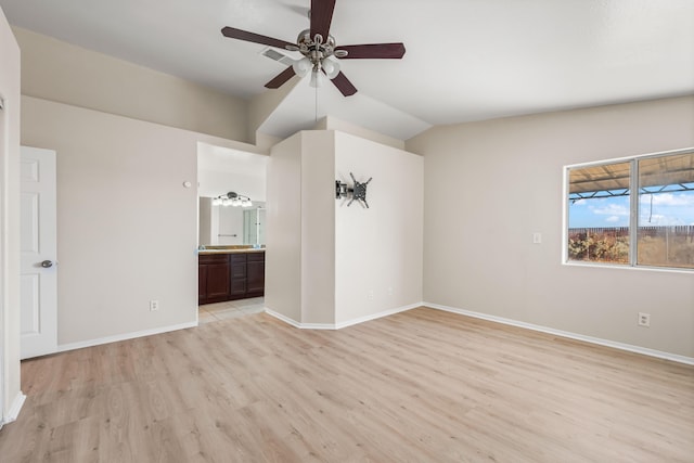 unfurnished room with ceiling fan, lofted ceiling, and light wood-type flooring