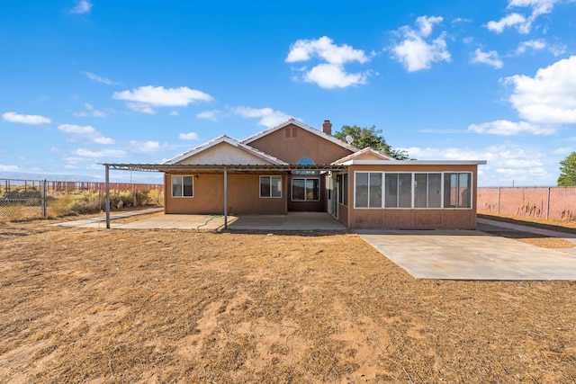 back of house with a pergola, a sunroom, and a patio