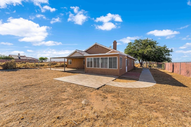 rear view of property with a pergola and a patio area