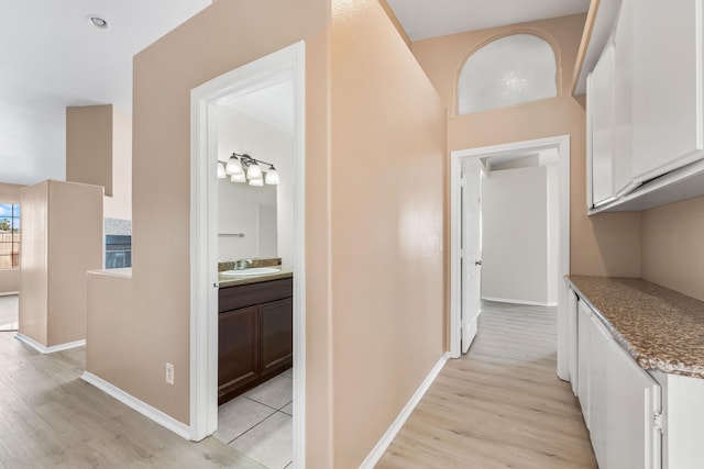 hallway featuring light hardwood / wood-style floors and sink