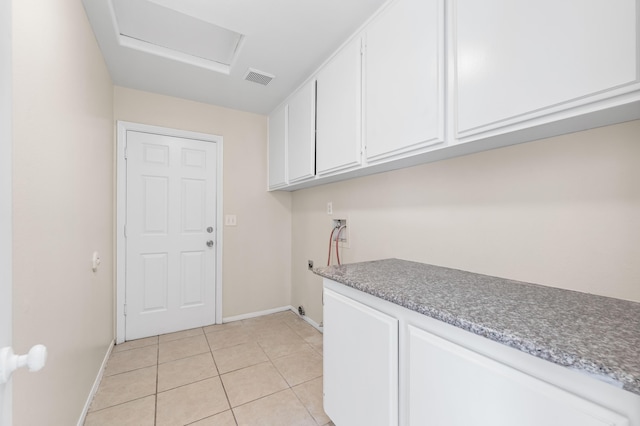 laundry area with cabinets, electric dryer hookup, washer hookup, and light tile patterned floors