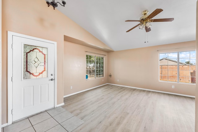 entryway with vaulted ceiling, ceiling fan, and light hardwood / wood-style flooring