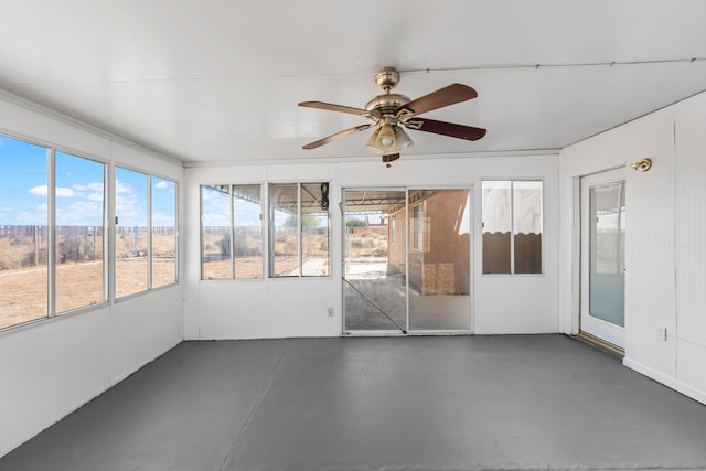 unfurnished sunroom with ceiling fan