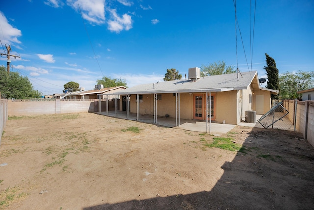 back of property featuring a patio area, a fenced backyard, central air condition unit, and stucco siding