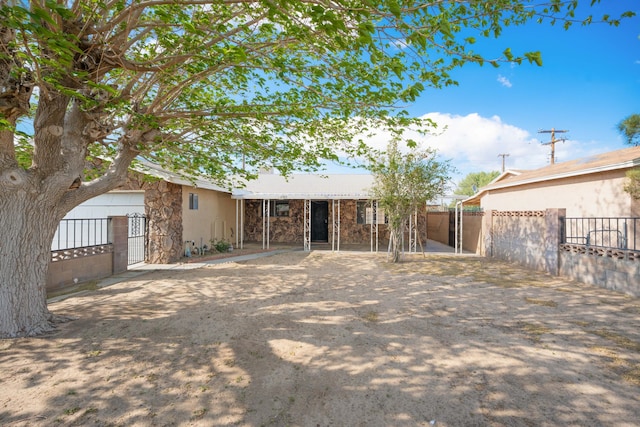 view of front facade with a gate, fence private yard, and stone siding