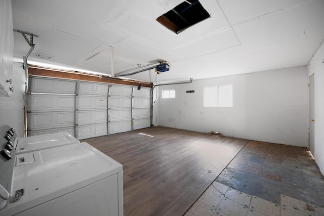 garage with washer and dryer and a garage door opener