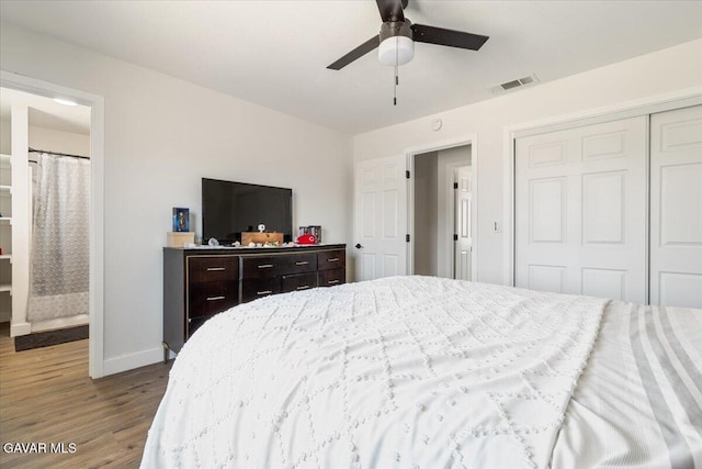 8649 Tamarack Ave, California City, CA 93505 - bedroom with wood finished floors, a closet, ensuite bath, and ceiling fan