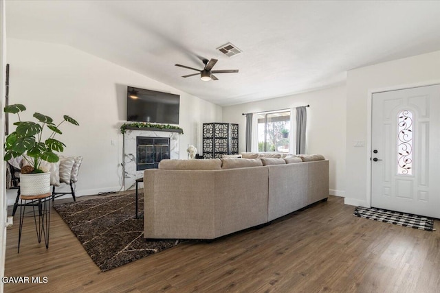 8649 Tamarack Ave, California City, CA 93505 - living room with dark wood-style floors, ceiling fan, a fireplace, and vaulted ceiling