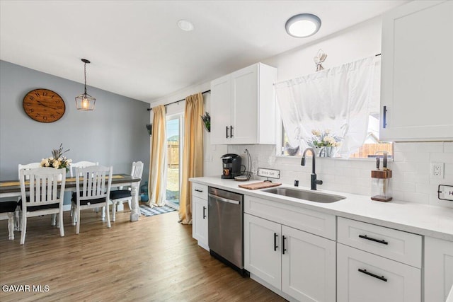 8649 Tamarack Ave, California City, CA 93505 - kitchen with decorative backsplash, dishwasher, light countertops, and white cabinetry