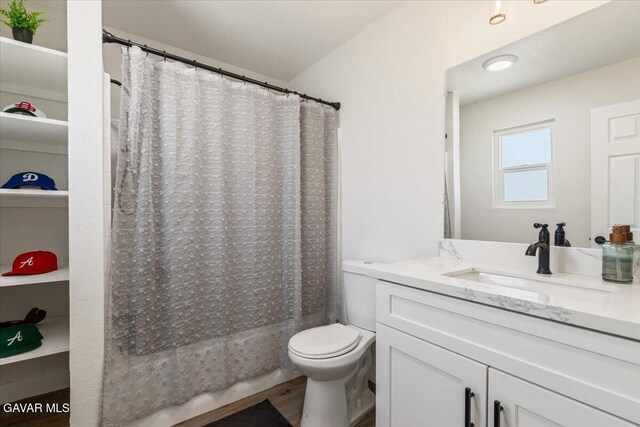 8649 Tamarack Ave, California City, CA 93505 - bathroom with vanity, shower / bath combination with curtain, and wood finished floors
