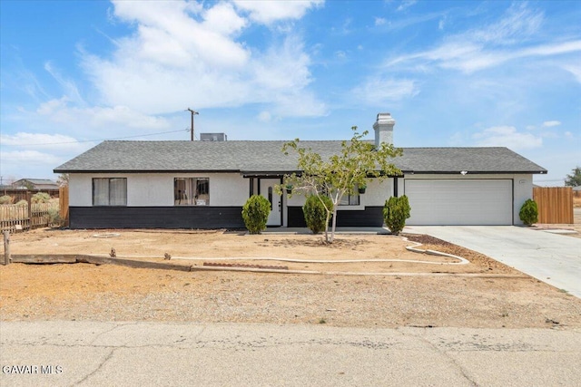 8649 Tamarack Ave, California City, CA 93505 - ranch-style home featuring an attached garage, driveway, roof with shingles, and a chimney