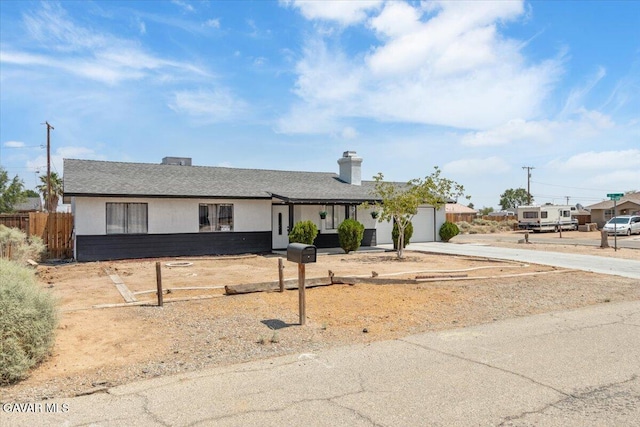 8649 Tamarack Ave, California City, CA 93505 - single story home with concrete driveway, a garage, a chimney, and a shingled roof