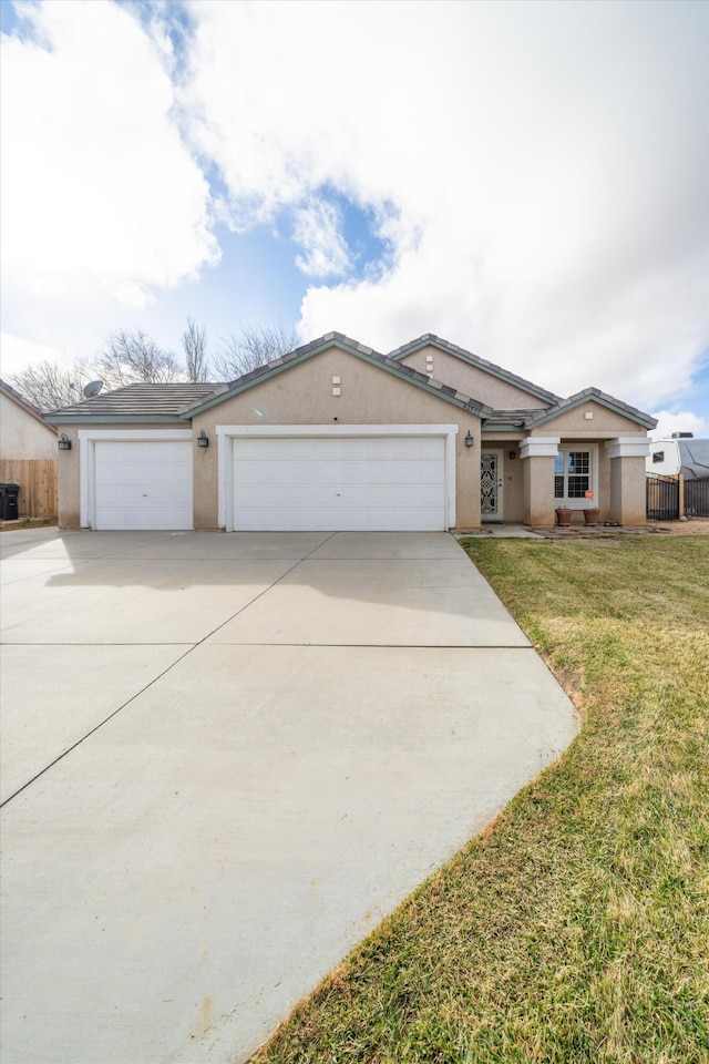 ranch-style house with a garage and a front lawn