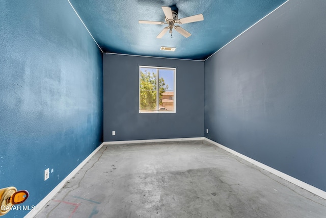 2407 Bavarian Ave, Rosamond, CA 93560 - empty room featuring concrete flooring, a textured ceiling, and ceiling fan