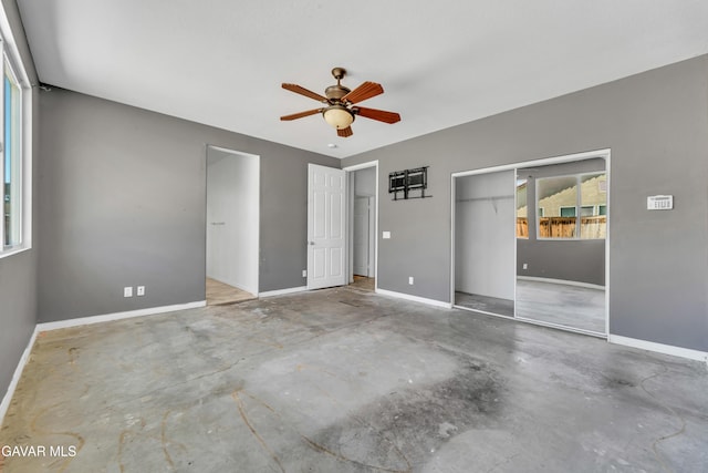 2407 Bavarian Ave, Rosamond, CA 93560 - unfurnished bedroom with unfinished concrete flooring, a closet, and a ceiling fan