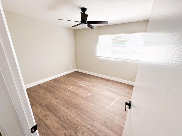 spare room with light wood-style flooring, baseboards, and ceiling fan