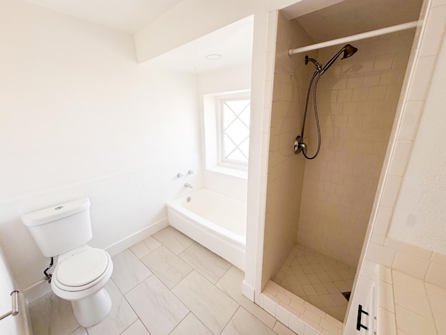 bathroom featuring a garden tub, a shower stall, and toilet